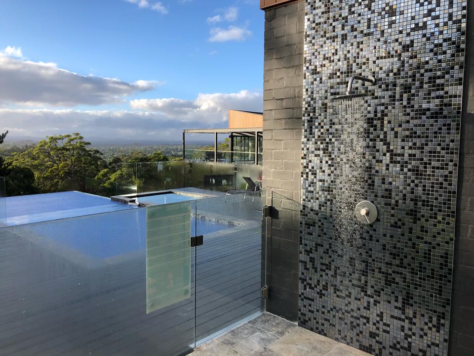 Outdoor shower with scenic forest view
