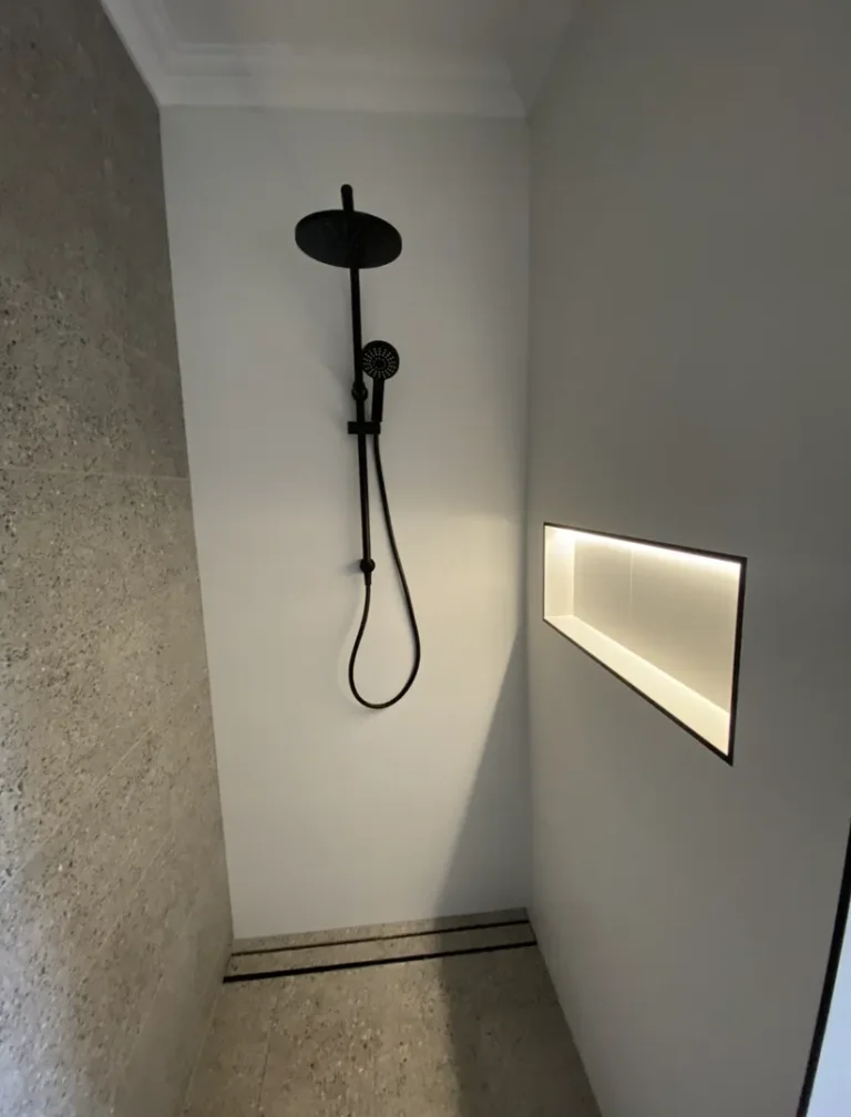 Modern shower stall with black showerhead