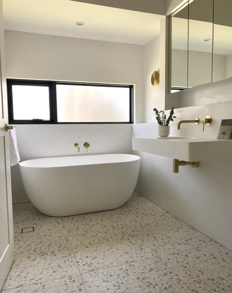 Modern bathroom with freestanding tub and sink.