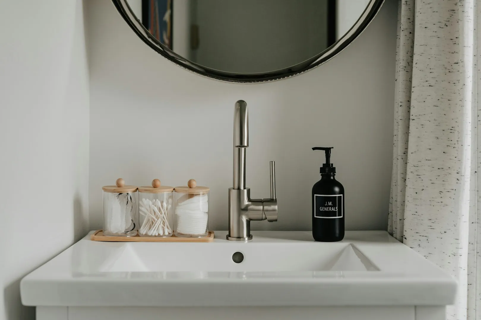 Modern bathroom sink with toiletries.